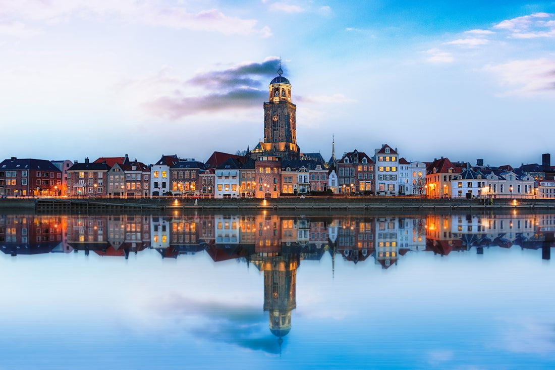 lighted buildings across placid lake