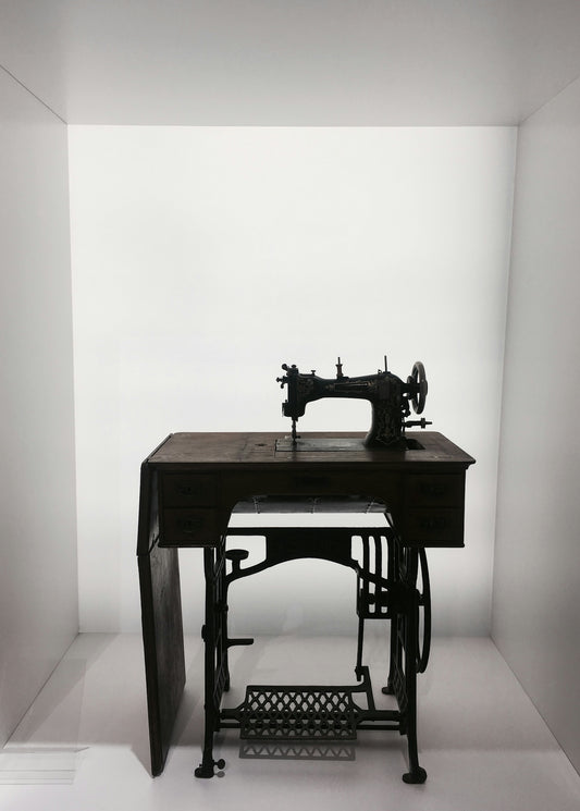 a sewing machine sitting on top of a wooden table