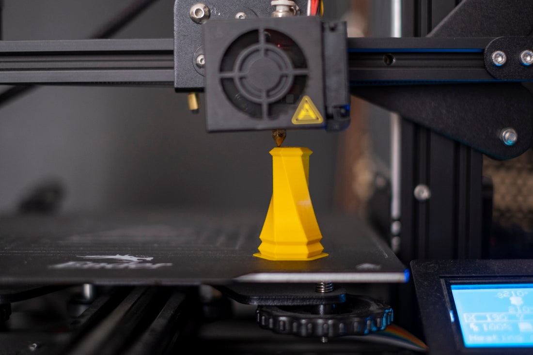 a 3d printer with a yellow cone on top of it
