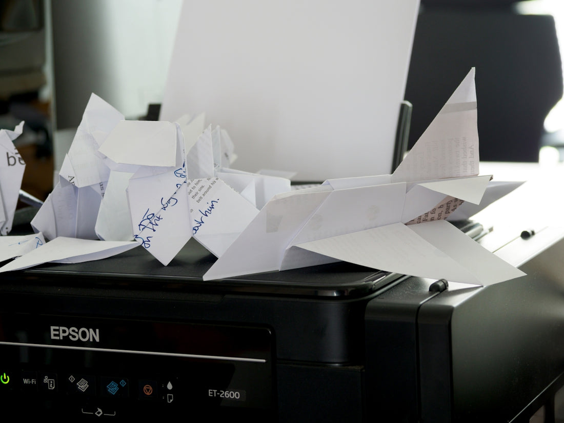 a bunch of papers sitting on top of a printer