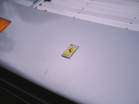 a yellow sticker on a white wall