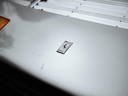 a white surface with a black and white sign on it