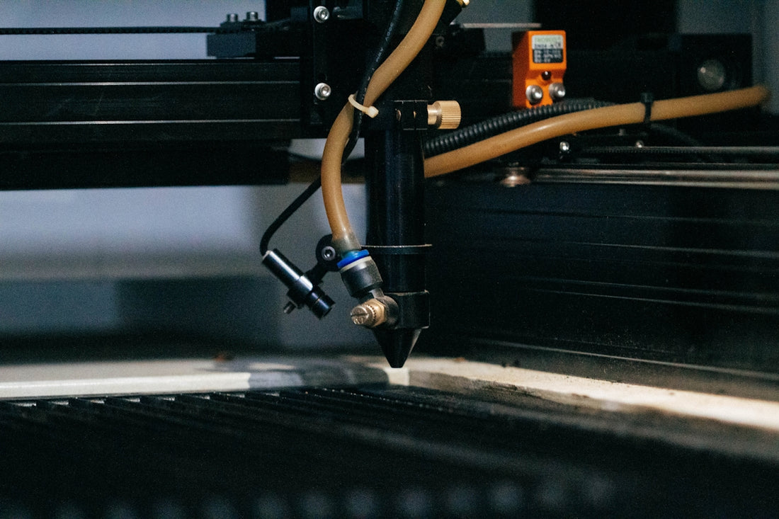 a machine that is cutting a piece of metal