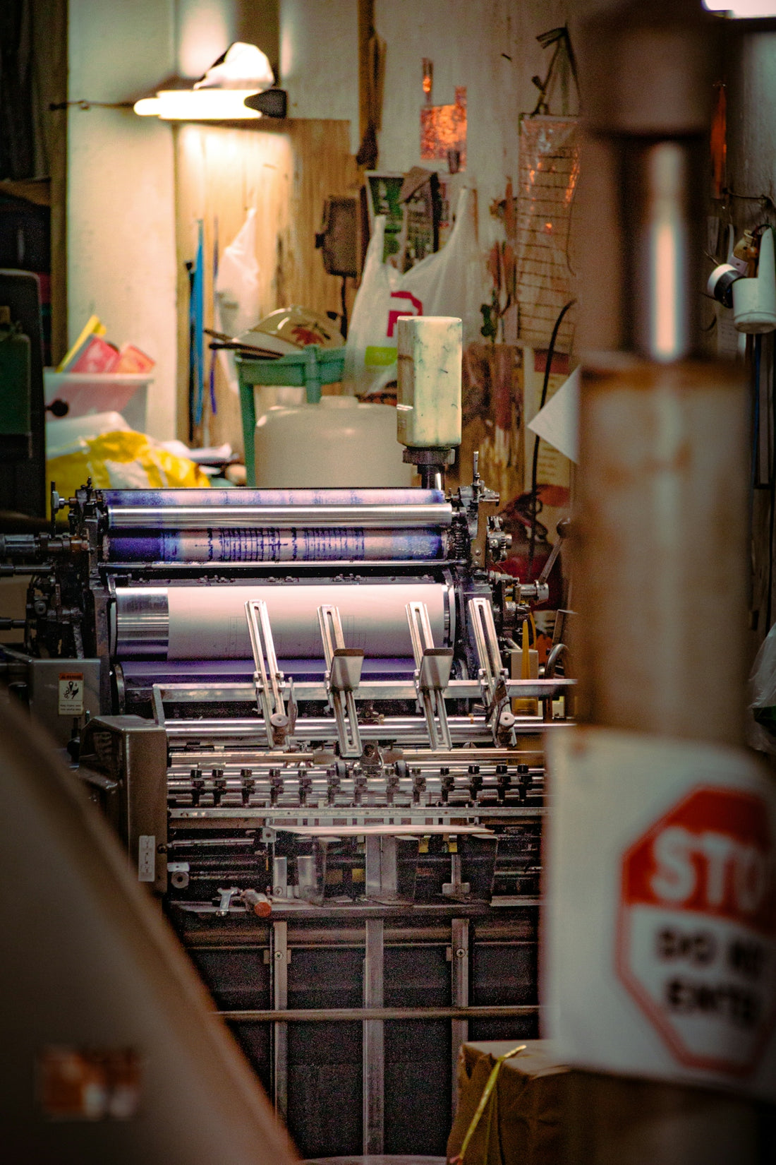 Industrial printing press with purple ink rollers.
