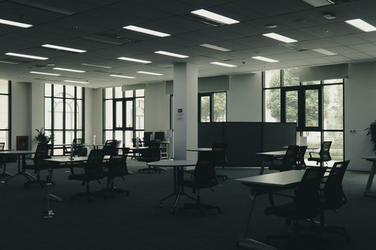 Empty modern office space with tables and chairs.