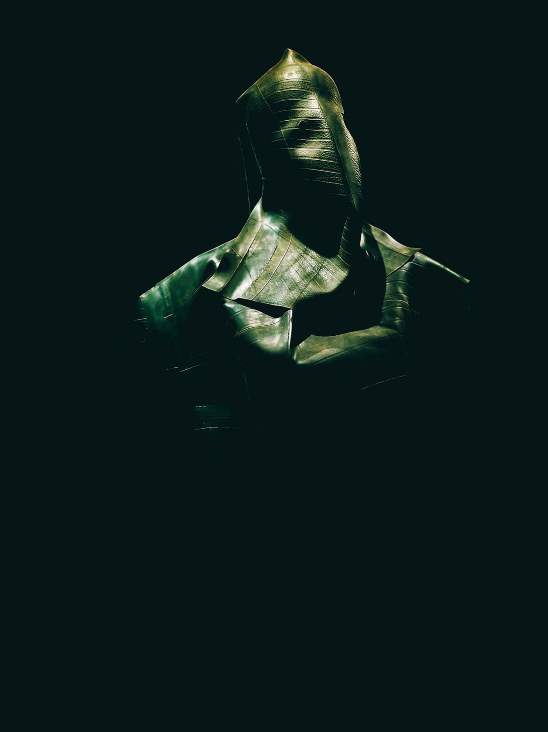 Abstract bust with textured surface in darkness