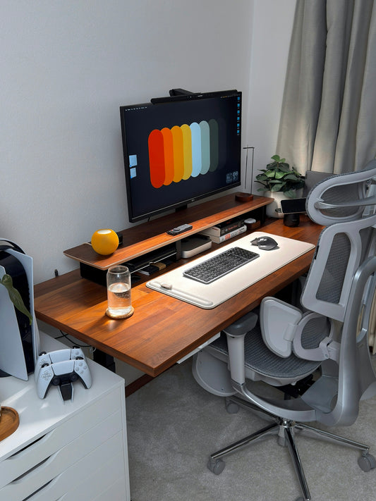 A modern desk setup with computer and gaming console.