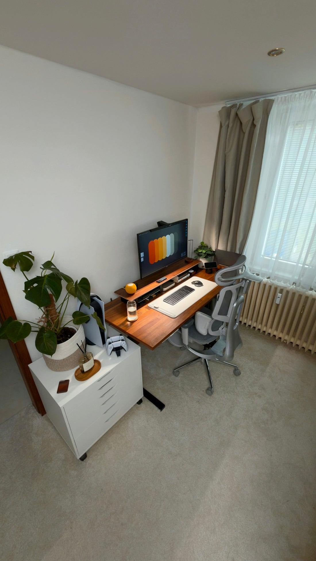 A modern home office with a standing desk and computer.