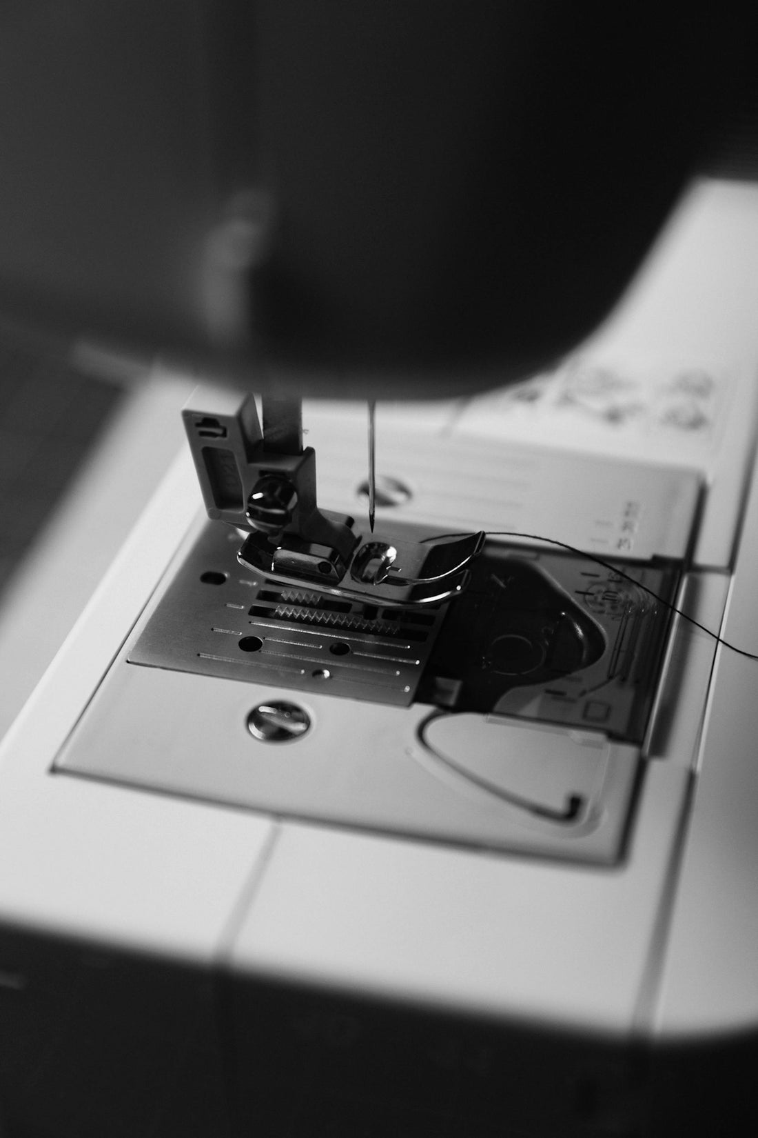 Close-up of a sewing machine needle and needle.